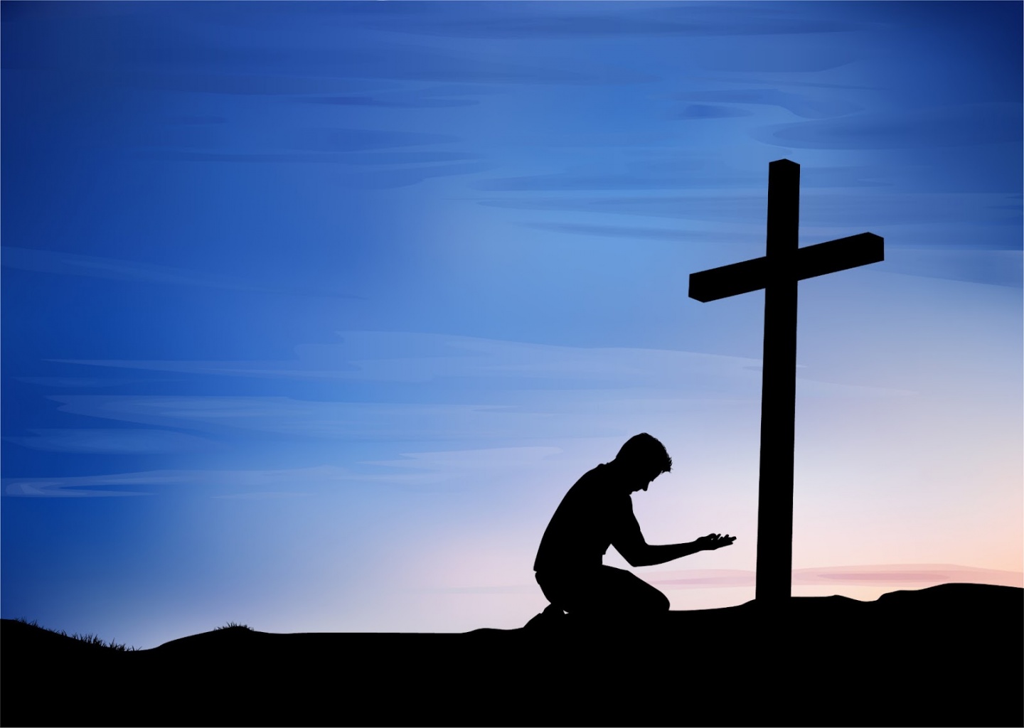 Человек молится перед крестом